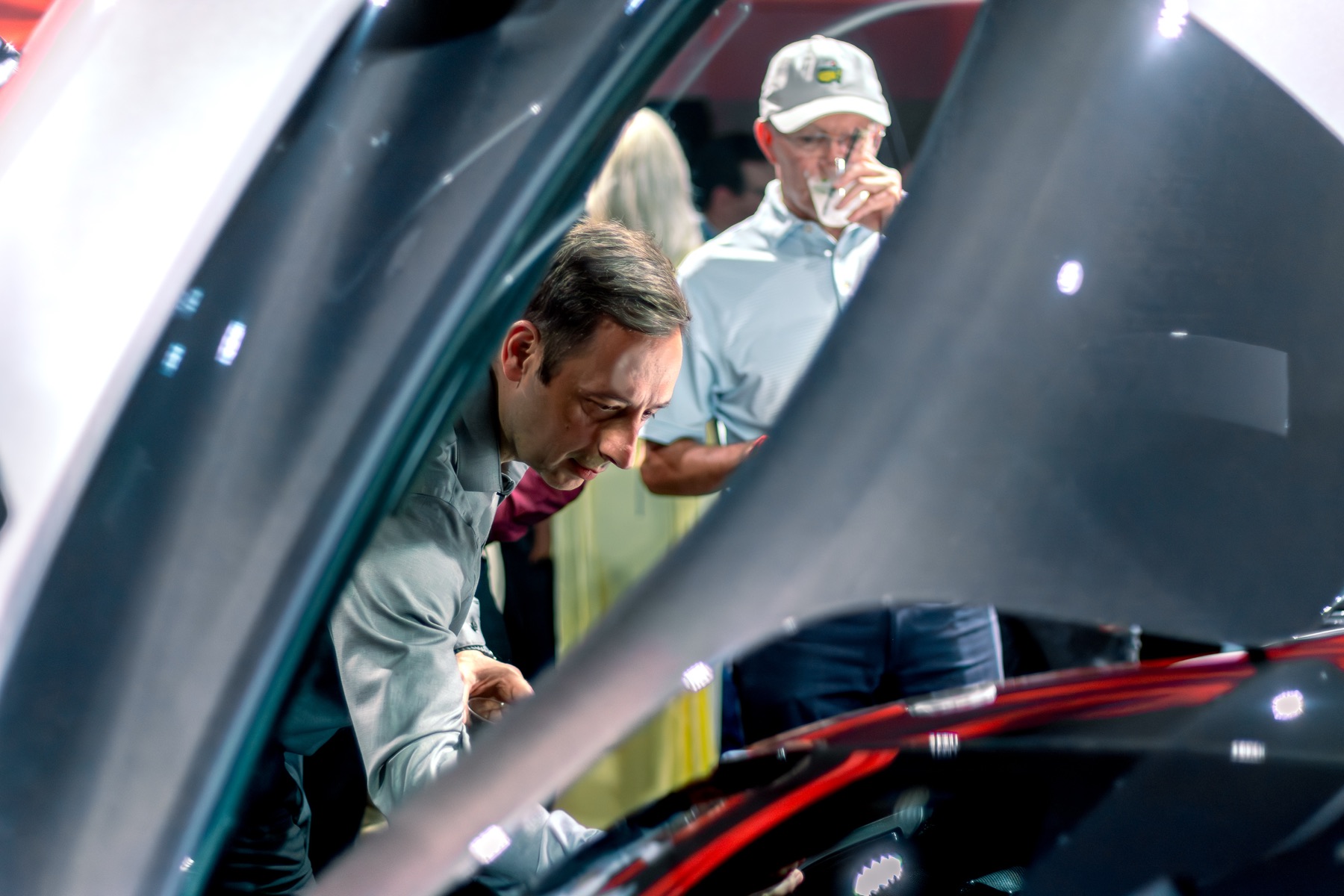 Guests examining the Ferrari F80 cockpit